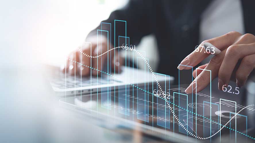 Business professional analyzing digital financial data on a transparent screen, symbolizing financial management and reporting.