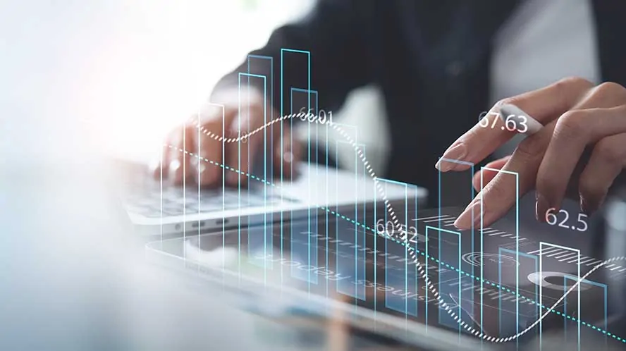 Business professional analyzing digital financial data on a transparent screen, symbolizing financial management and reporting.